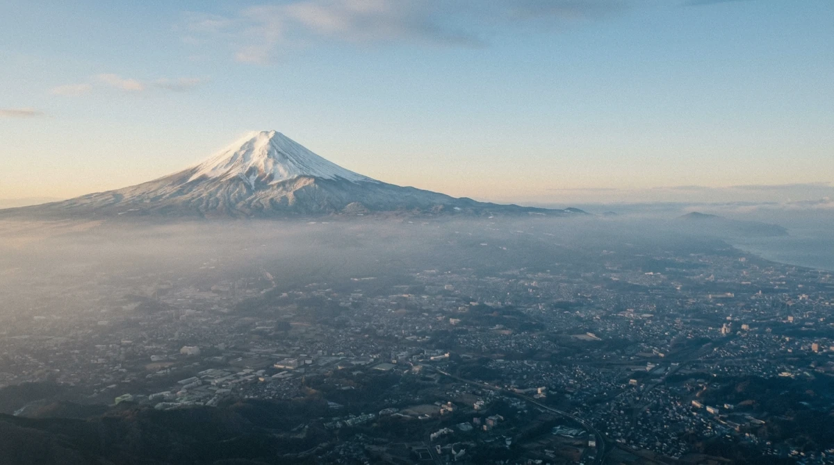 Mount Fuji above the haze on the horizon, the clear-day bonus view on a Tokyo helicopter tour